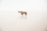 Side profile of a vintage African bronze rhino showing its rustic, hand-cast details.