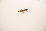 Full view of the miniature African rhino sculpture in tinted bronze.