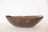 Organic uneven rim and primitive hand-carved texture of the vintage African bowl.