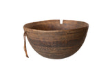 Aged vintage African hand-carved wooden bowl with primitive patterns and rich dark brown patina.