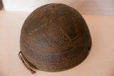 Primitive hand-carved geometric patterns and aged brown texture of a vintage African bowl.