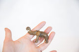 Vintage African bronze elephant sculpture with aged patina held in hand to show its size.