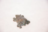 Vintage copper turtle with time-softened green tones on its textured shell.