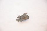 Vintage African copper turtle, angled view of its textured underside and rich green patina.