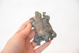 Small handmade copper turtle sculpture, featuring an aged green patina.