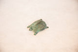 Vintage African copper turtle with prominent green patina and textured shell.