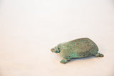 Time-softened green patina on the vintage African copper turtle's textured shell.