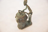 Stylized form and oxidized patina of a vintage African drummer sculpture.
