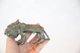 Vintage copper animal sculpture with green patina, held to show scale.