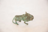 The walking form and textured green patina of a vintage African copper animal sculpture.