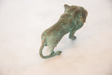 Textured patina on the sculpted back and curled tail of the vintage copper wild thing.
