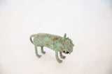 Side view of the vintage African wild thing highlighting its mottled copper patina.