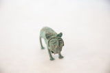 Detailed front view of a vintage copper animal sculpture's expressive, patinated face.
