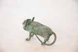 Rear view of the vintage African copper animal showing its textured patina and curled tail.