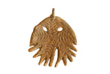 Handmade vintage African bronze jellyfish pendant with etched patterns and a rustic, aged patina.