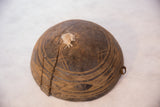 Aged crack and hand-carved lines on the side of the vintage African wooden bowl.