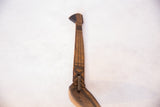 Hand-carved geometric patterns and metal repair on the vintage wooden spoon's handle.