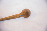 Close-up of vintage African hand-carved wooden spoon head with metal staple repairs.