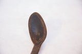 Dark, hand-carved primitive bowl of the vintage African spoon, with textured patina.