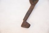 Dark, hand-carved, angled end of the vintage African wooden spoon handle.