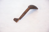 Patina and weathered texture of the vintage African wooden spoon's handle.