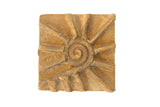 Vintage square African bronze coin with a raised spiral sunburst motif.