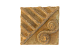 Vintage African square bronze coin with a raised pattern of diagonal lines and a double spiral motif.