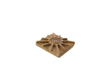 Vintage African square bronze coin with an aged patina and a central spiral sunburst motif.