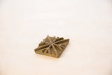 Angled close-up of a vintage bronze coin showing its rustic texture and raised design.
