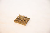 Angled view of the vintage bronze coin, showing its handmade texture and raised pattern.