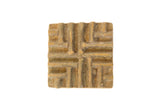 Vintage square African bronze coin with a raised, textured geometric pattern.