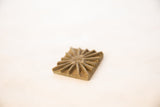 Angled view of a vintage bronze coin highlighting its handmade texture and profile.