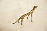 Vintage African bronze cheetah's textured head and elongated neck, close-up.