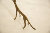Textured hind legs and curled tail of the vintage African bronze cheetah.