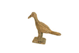 Vintage African bronze bird collectible with a matte patina and etched circular wing details.