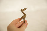 Vintage African bronze bird held in hand to show the scale and handmade texture.