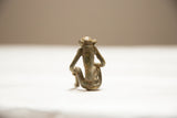 Collectible vintage African bronze monkey sculpture, rear view with aged green-brown texture.