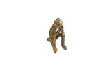 Handmade vintage African bronze monkey sculpture with a thoughtful pose and aged patina.