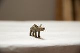 Side view of the vintage African bronze boar showing its hand-cast texture and form.