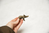 Vintage African bronze boar held in hand to demonstrate its scale.