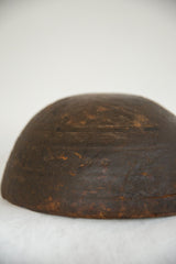 Close-up of the vintage African wooden bowl's dark wood, highlighting aged texture and imperfections.