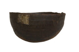 Vintage African wooden bowl, handmade, dark brown with visible repairs and aged character.