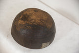 Vintage African wooden bowl, dark weathered wood with metal repair patch.