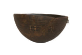 Dark brown vintage African wooden bowl with a weathered patina and subtle carved patterns.