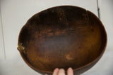 Interior of vintage African wooden bowl, dark brown wood showing aged cracks and texture.