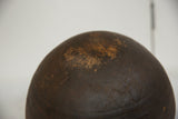 Close-up of the vintage African wooden bowl's dark brown surface with textured wear.