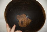 Interior detail of the vintage African wooden bowl, revealing natural wood grain and storied patina.