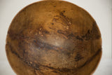 Vintage African wooden bowl interior detail, showing natural cracks and dark wood patina.