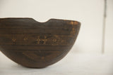 Hand-carved zigzag and diamond patterns on vintage African wooden bowl.