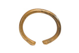 Antique African bronze bracelet with a simple open cuff showing an aged, time-softened patina.